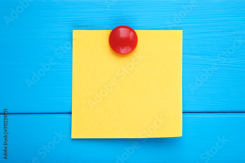 Paper sticky note on blue wooden table