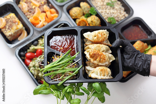 Meal prep containers, the chef prepares a meal in a boxed diet delivered to order.