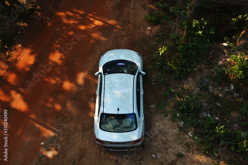 Close up of top view of a white Indian car standing in a forest in the district of Bankura, West Bengal, India © RUPAK