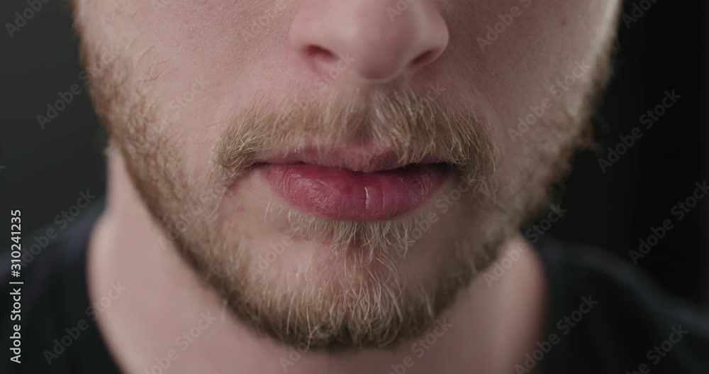 Slow motion closeup shot of bearded man mouth laughing Slow motion closeup shot of bearded man mouth laughing
