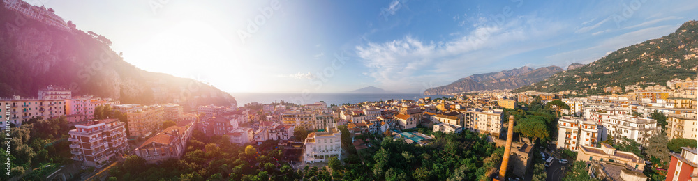 Beautiful panoramic aerial view on the center of Sorrento city, sunset, houses and streets, sea views and a Vizuvius, Napoli in the distance. Travel and vacation concept on Italy. Infrastructure.
