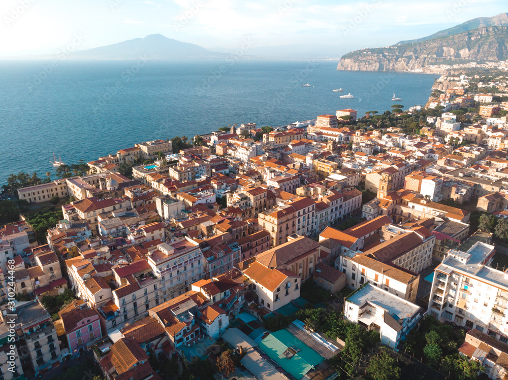 Aerial view on the center of Sorrento city, sunset, houses and streets, sea views and a Vizuvius, Napoli in the distance. Travel and vacation concept on Italy. Infrastructure.