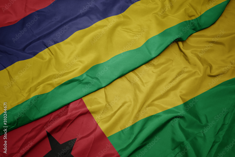 waving colorful flag of guinea bissau and national flag of mauritius.