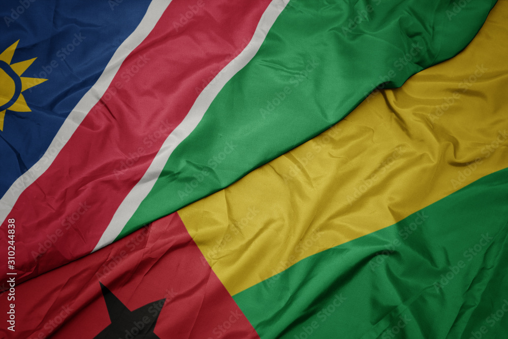 waving colorful flag of guinea bissau and national flag of namibia.