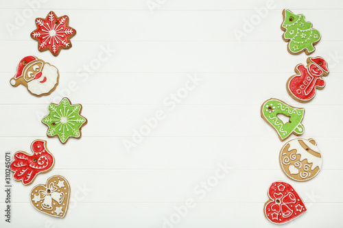 Christmas gingerbread cookies on white wooden table