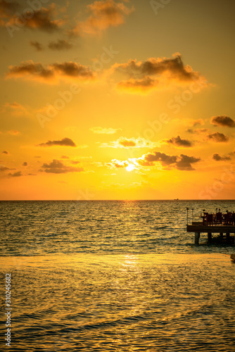stunning and beautiful sunset on an island with a colorful horizing and the sun setting  © Joerg