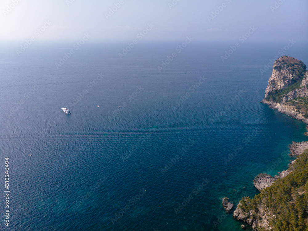 Beautiful aerial view of mountains and sea on sunrise. Marine Park. Trail for active sports, hiking along the mountain to a wild beach, tourist destination. Nerano, Massa Lubrense, Ieranto bay, Italy