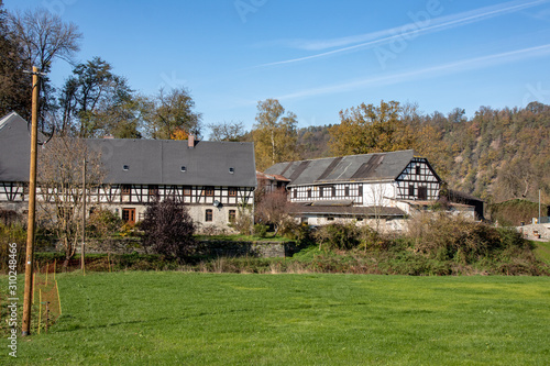 Romantic autumn landscape with river Elster with beautifully renovated old farm near the place Neumühle,Elster in Thuringia,Germany a beautiful hiking area
