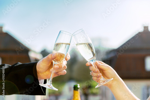 Weddingcouple holding champagne drinking champagne toast cheers photo