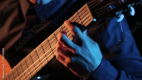 man masterfully plays acoustic guitar, close-up of guitar strings and fretboard, isolated