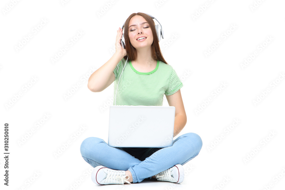 Young woman in headphones using laptop computer on white background Young woman in headphones using laptop computer on white background