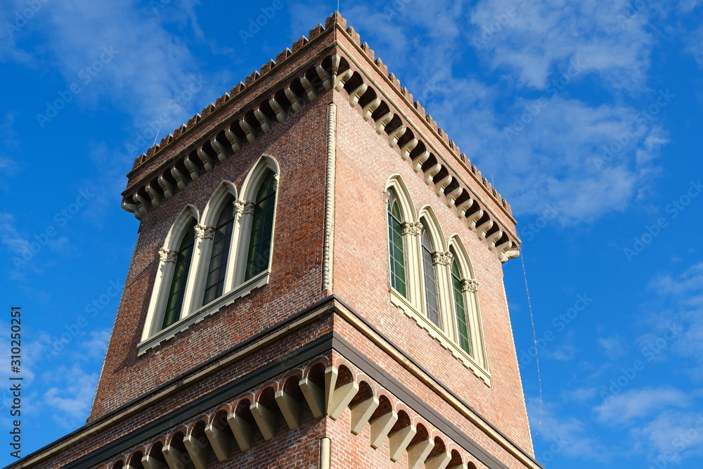 Neo-Gothic tower. Textile Museum in Busto Arsizio. Neo-Gothic construction in terracotta bricks with turrets and ogival windows.
