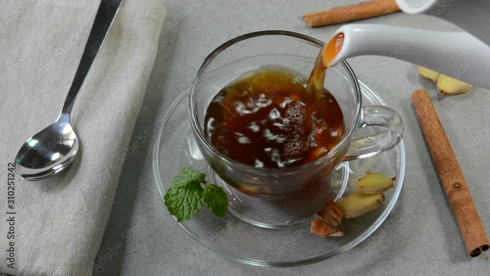 Pouring ginger cinnamon mint tea glass tea cup Pouring ginger cinnamon mint tea glass tea cup