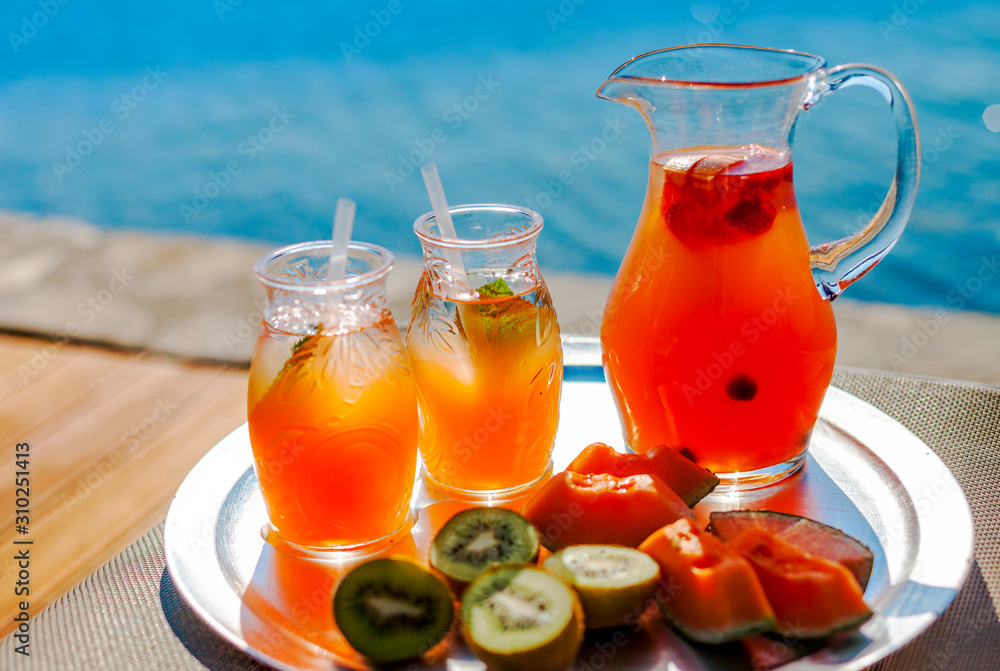 Lemonade and fruit on the beach by the sea. Lemonade and fruit on the beach by the sea.