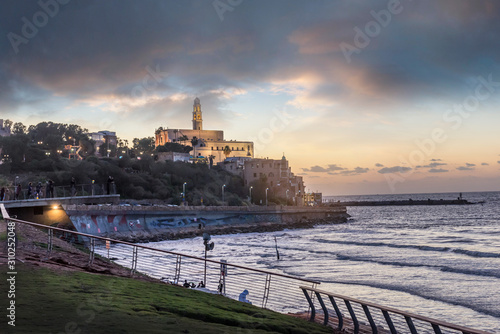 Fototapeta Naklejka Na Ścianę i Meble -  TEL AVIV, ISRAEL - waterfront and beach of old Jaffa Sunset ,cloudy