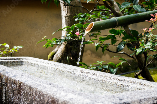 Water flowing from a bamboo spout at a Zen temple