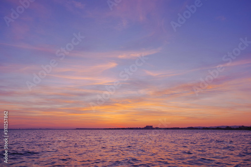 Colorful sunset over the sea. Purple sky.