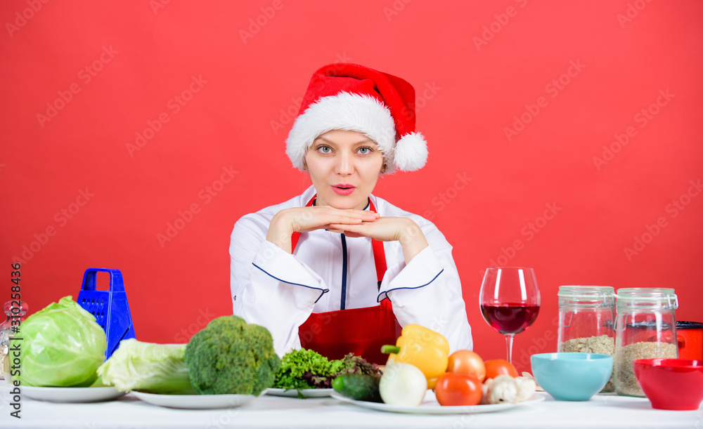 Woman chef santa hat cooking at kitchen. Christmas dinner idea. Cooking for family. Healthy christmas holiday recipes. Easy ideas for christmas party. Best christmas recipes of perfect housewife Woman chef santa hat cooking at kitchen. Christmas dinner idea. Cooking for family. Healthy christmas holiday recipes. Easy ideas for christmas party. Best christmas recipes of perfect housewife
