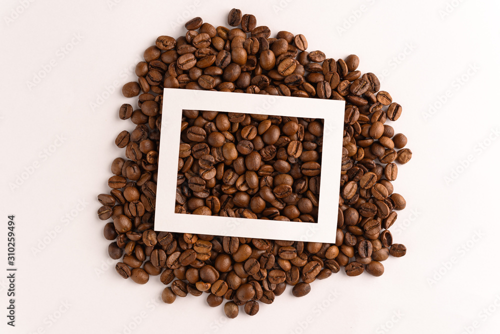 Coffee bean layout with cut out paper frame on white background Coffee bean layout with cut out paper frame on white background