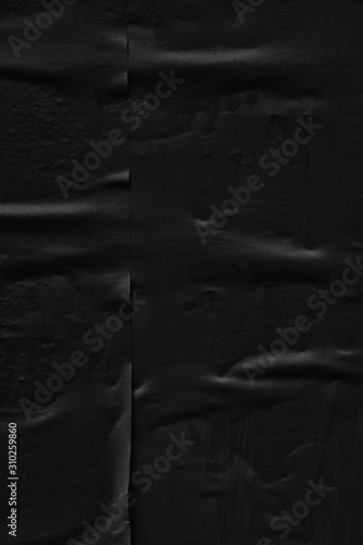 Dark black paper background creased crumpled blank posters old torn ripped surface grunge textures placard backdrop empty space for text    