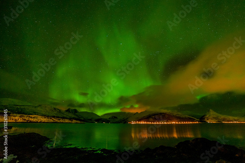 unforgettable aurora borealis, northern lights, over city in the North of Europe - Lofoten islands, Norway