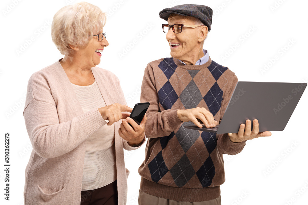 Fotografie Senior people using modern technology, a laptop computer and a smartphone