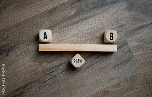 Cubes dice with plan a and plan b on wooden background photo