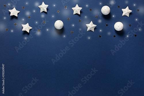 Fototapeta Naklejka Na Ścianę i Meble -  Christmas decorative stars and shiny balls on classic blue background. Holiday greeting card.