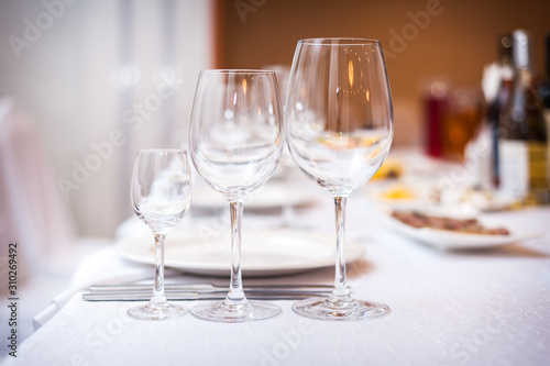 Empty wine glasses set in the restaurant.