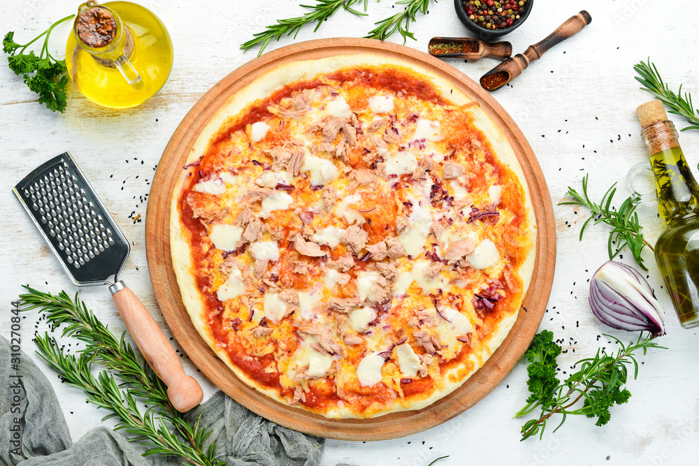 Traditional pizza with tuna and vegetables. Top view. free space for your text. Rustic style.