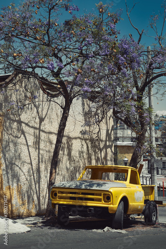 Old yellow truck on the street of Mexico city