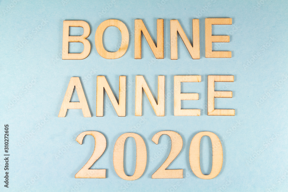 Happy new year in french language and 2020 in wooden figures