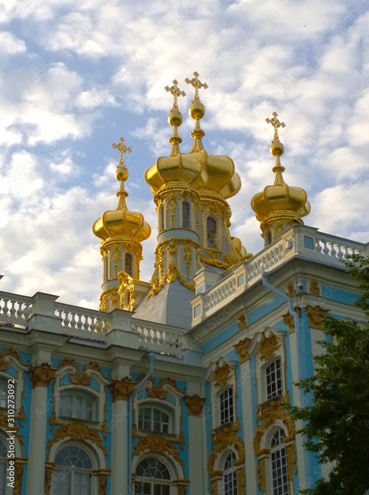 Golden domes with crosses of the Catherine Palace Church in Pushkin (Tsarskoye Selo), a suburb of St. Petersburg, Russia. Russian royal tourist attractions, travelling. Famous excursion place.