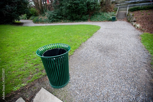 Photography Wide angle view of trash can by a path in a park