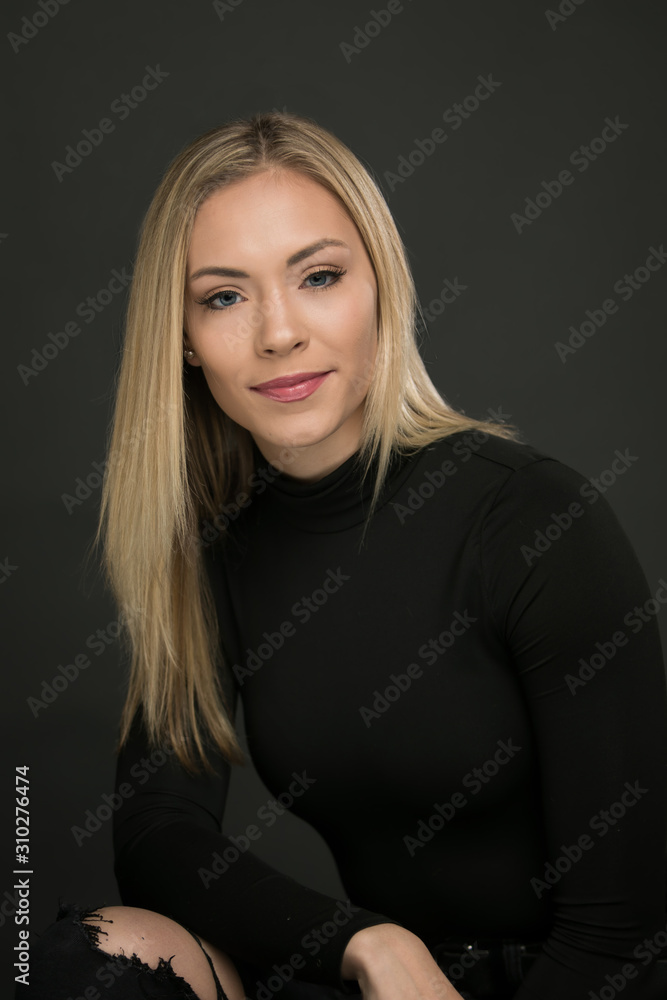 Beautiful portrait of smiling blond woman on a black background Beautiful portrait of smiling blond woman on a black background
