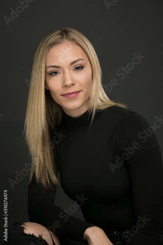 Beautiful portrait of smiling blond woman on a black background