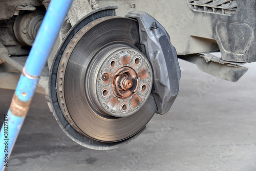 Brake disc with brake pads on an automobile