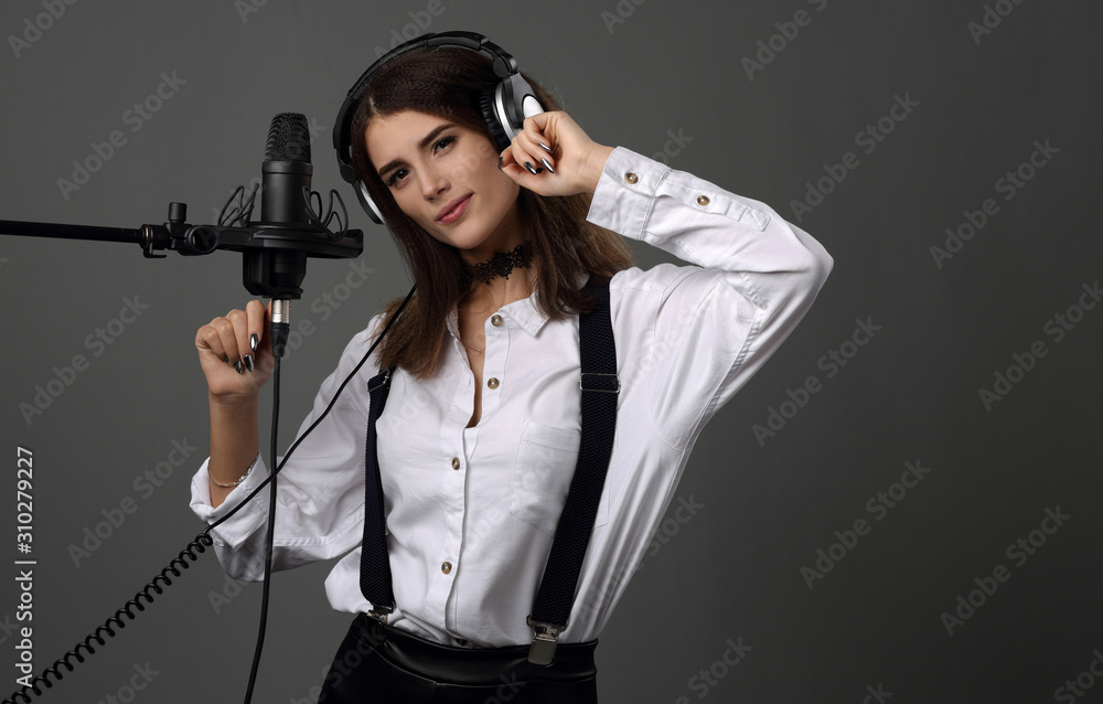 Beautiful girl on the background of a Studio microphone Beautiful girl on the background of a Studio microphone