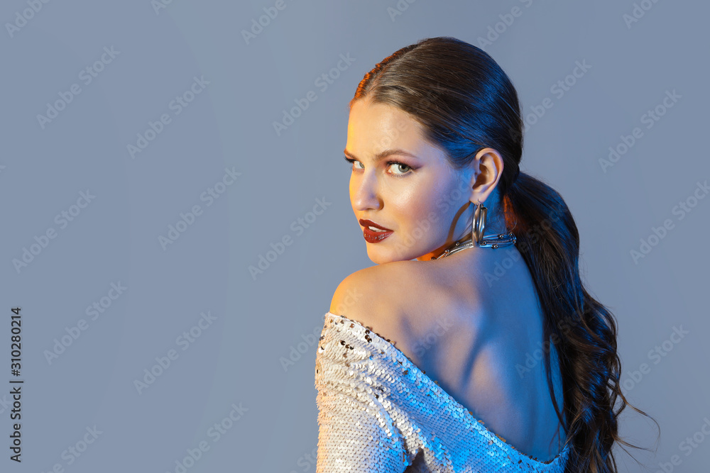 Portrait of stylish young woman on grey background Portrait of stylish young woman on grey background