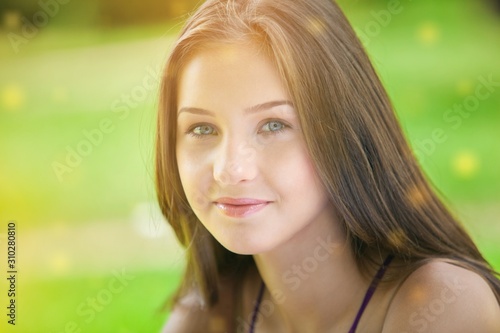 Young woman on field under sunset light