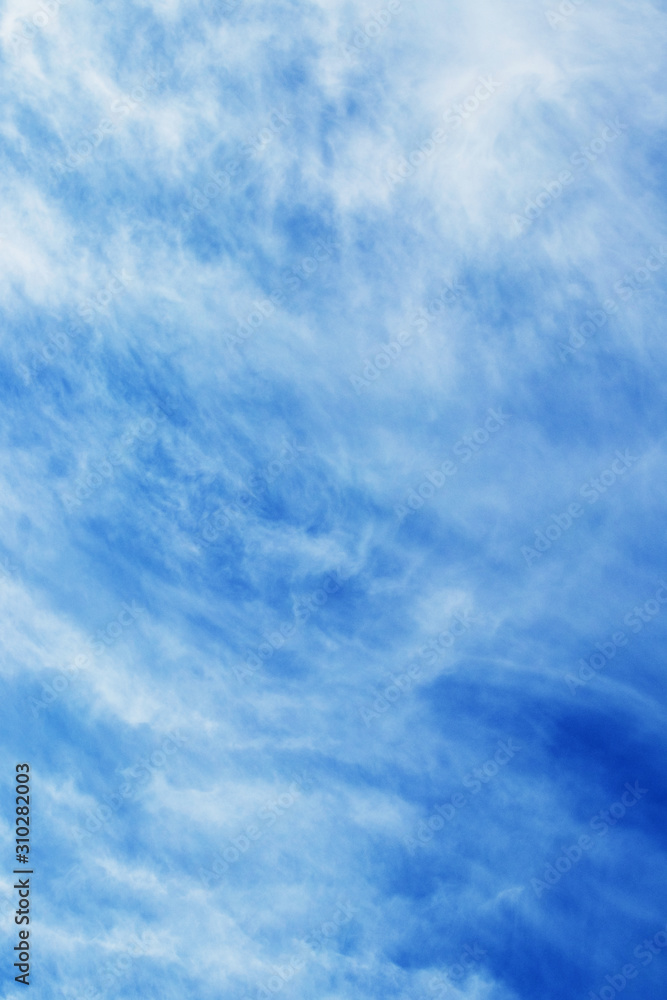 Abstract background with clouds of uncertain shape in blue sky_