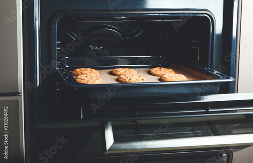 Baking tray with tasty cookies in oven