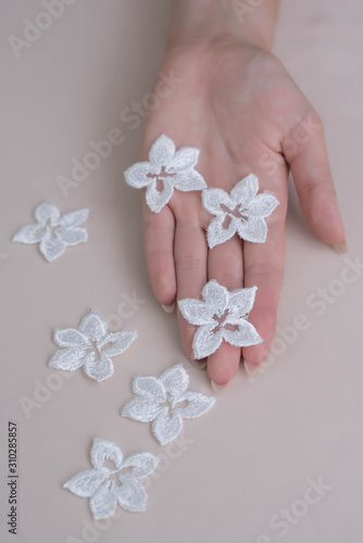 Texture lace fabric. lace on white background studio. thin fabric made of yarn or thread. a background image of ivory-colored lace cloth. White lace on beige background.