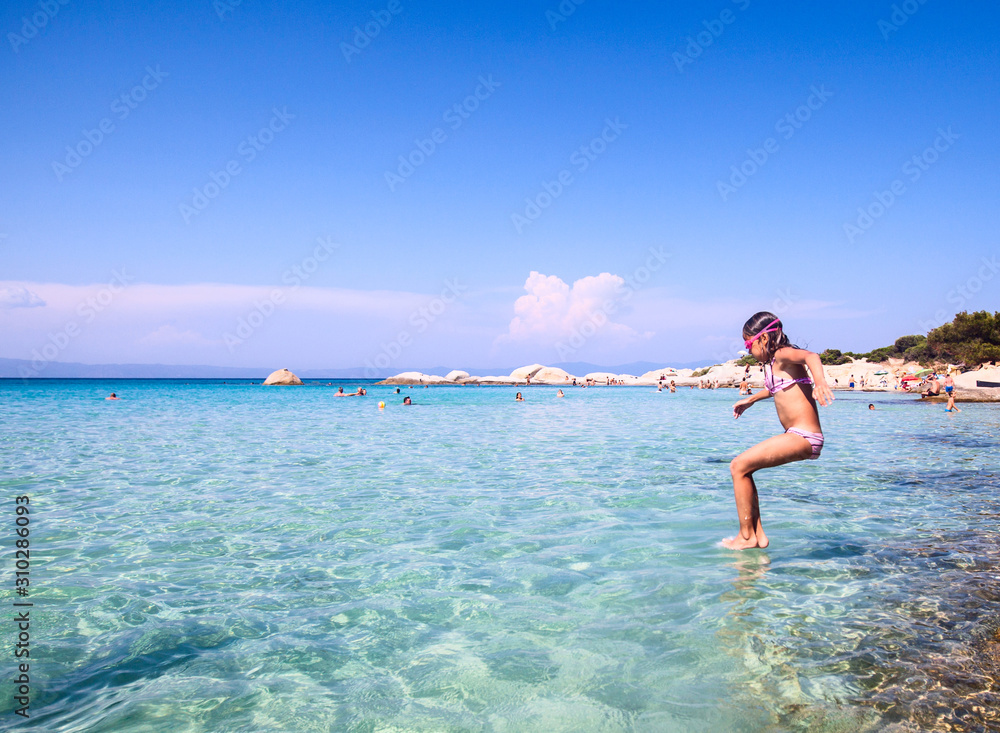 Child jumping in the sea