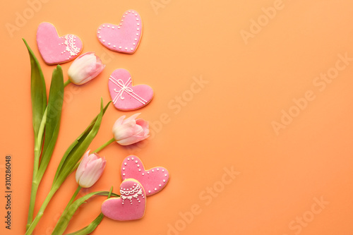 Tulip flowers and heart shaped cookies for Valentine's day on color background © Pixel-Shot