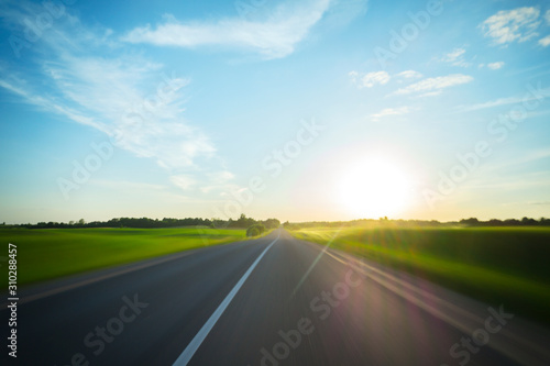 A journey through the rural road to the sun, motion blur