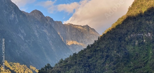 Milford Sound Fjord, Milford Sound / New Zealand - December 18, 2019: The Dramatic Mountains and Waterfalls of the Milford Sound Fjord, New Zealand photo