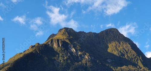 Milford Sound Fjord, Milford Sound / New Zealand - December 18, 2019: The Dramatic Mountains and Waterfalls of the Milford Sound Fjord, New Zealand photo