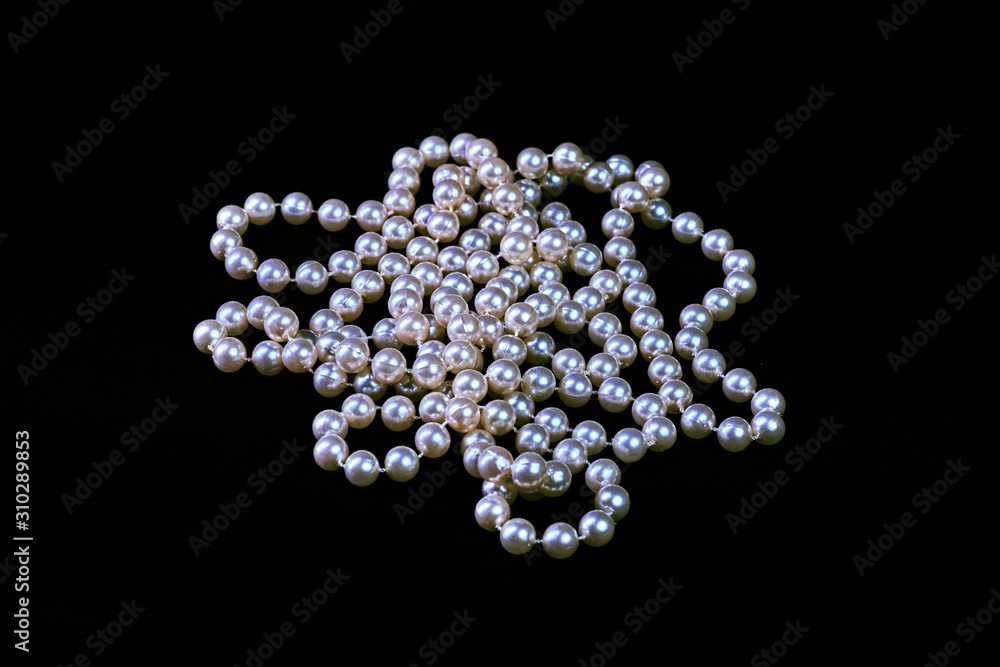 Fashionable necklace of genuine pearls on a black background isolated Fashionable necklace of genuine pearls on a black background isolated