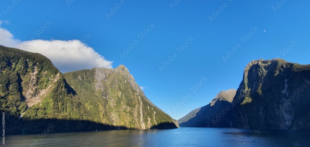 Milford Sound Fjord, Milford Sound / New Zealand - December 18, 2019: The Dramatic Mountains and Waterfalls of the Milford Sound Fjord, New Zealand